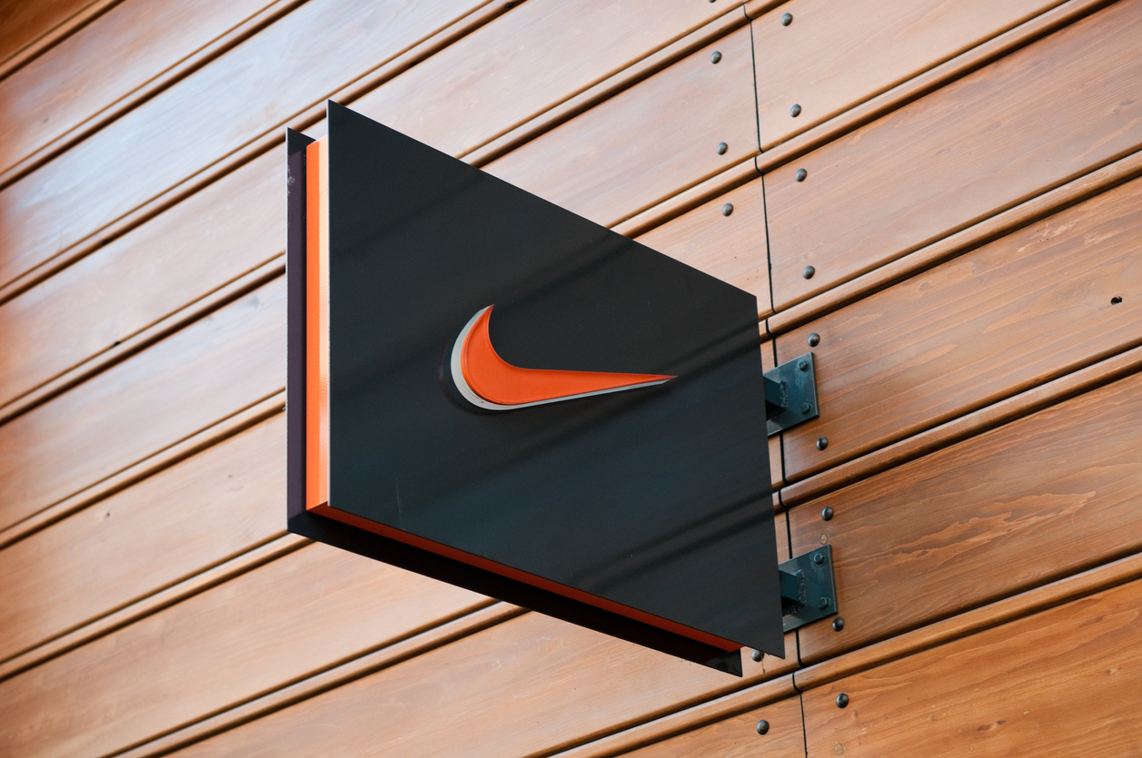 "London, United Kingdom - April 22, 2011: Nike store logo located in central London, near Covent Garden. The Nike Swoosh logo hanging from a house wall. Nike is a global sports clothes and running shoes retailer. Nike stores are located all over London. Covent Garden is a famous shopping area and tourist hot-spot."